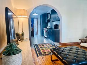 an archway in a living room with a couch and a kitchen at The White House in George +17 photos