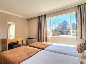 Ένα ή περισσότερα κρεβάτια σε δωμάτιο στο Carousel Eco Estate +40 φωτογραφίες