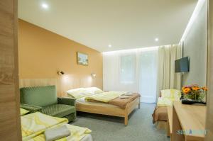 a hotel room with a bed and a couch at SeaPort Resort in Łeba