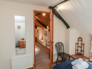 a bedroom with a bed and a door leading to a hallway at Bridge Cottage in Budleigh Salterton