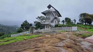 a house sitting on top of a hill at Anemoi Chimes Resort Calvarymount in Idukki