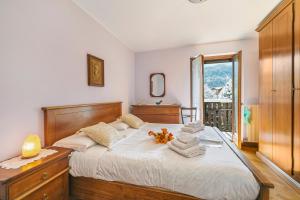 a bedroom with a large bed with towels on it at Maison Rosamunda - Happy Rentals in Oulx