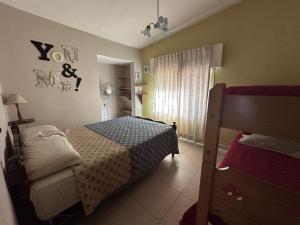 a small bedroom with a bed and a window at Casa Familiar Villa Carlos Paz in Villa Carlos Paz