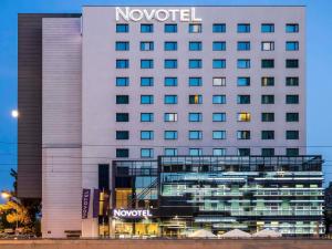 a hotel with a sign on the side of it at Novotel Lodz Centrum in Łódź +120 photos