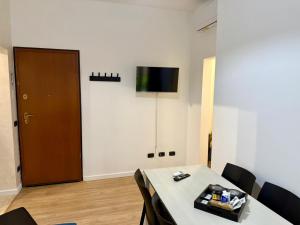 a room with a table and a television on a wall at Dea Bendata HERMES in Palestrina