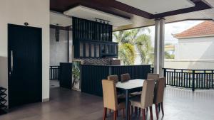 a kitchen and dining room with a table and chairs at Hi Cube Hostel in Canggu +7 photos