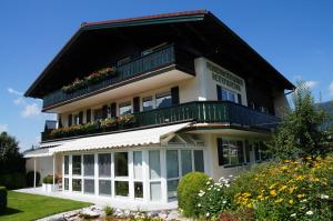 ein großes weißes Haus mit schwarzem Dach in der Unterkunft Ferienwohnungen Rettenbacher in Abtenau