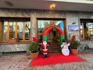 a house with two snowmen and a christmas door at Hotel Azzurra in Montecatini Terme