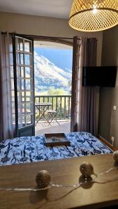 ein Schlafzimmer mit einem Bett und Blick auf einen Berg in der Unterkunft Gite Suyen, Bain nordique, Sauna in Arrens-Marsous