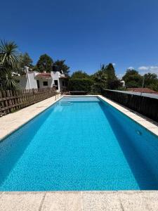 a swimming pool with blue water in a house at Casa Familiar Villa Carlos Paz in Villa Carlos Paz
