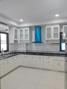 a large kitchen with white cabinets and blue appliances at Venice 3 bedroom, 3 bathroom, single family villa in Ban Nong Chaeng