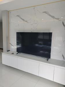 a large flat screen tv on a white wall at Venice 3 bedroom, 3 bathroom, single family villa in Ban Nong Chaeng