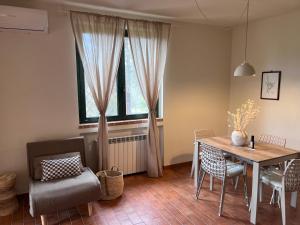 a dining room with a table and chairs and a window at Casetta Valmora in Valpiana +32 photos