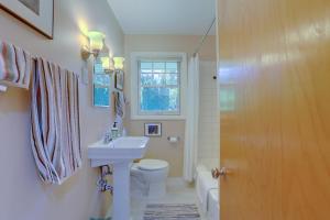 a bathroom with a sink and a toilet and a window at Living Color Cottage in Hood River +18 photos