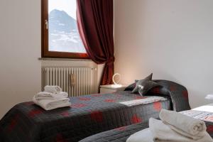 Postel nebo postele na pokoji v ubytování La Faustina Aosta