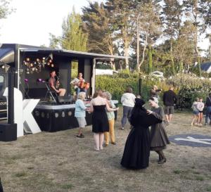 a group of people standing around a food truck at Mobil-home Les volets rouges in Plouhinec