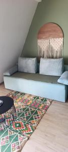 a blue couch in a room with a rug at Divčibarski kutak in Divčibare