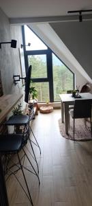 a dining room with a table and chairs and a large window at Divčibarski kutak in Divčibare