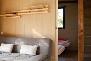a living room with a couch and a bunk bed at Chalet 35m2 - Armen in Plouhinec