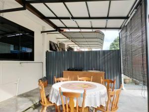 a dining room with a table and chairs at HANNI HomeStay in Sibu
