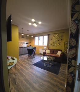 a living room with a couch and a table at SPA & SAUNA lin pour l'autre in Calais