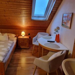 a bedroom with a bed and a table and chairs at Gästezimmer Aschenbrenner in Bad Rodach