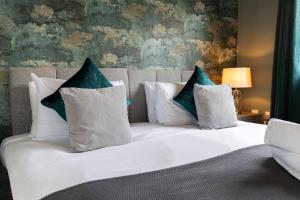 a bedroom with a white bed with blue pillows at Bridges Retreat, Newcastle in Gateshead +33 photos