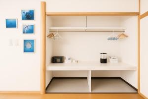 a kitchen with a white desk in a room at Yellow House Niseko in Kutchan