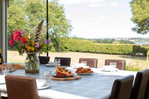 a table with a vase of flowers and food on it at Lakeside in Compton Martin +6 photos