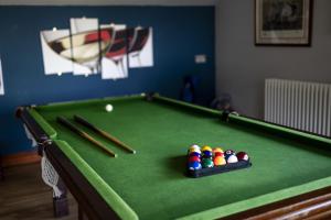 a green pool table with cue balls and bats at Lakeside in Compton Martin