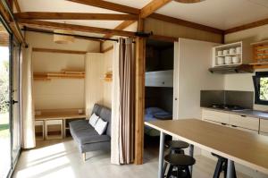 a kitchen and dining room with a table and chairs at Chalet 30m2 - Eckmühl in Plouhinec