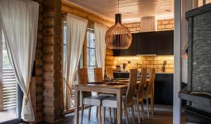 a kitchen with a wooden table and chairs in a room at Villa Marrikka, Levi in Levi