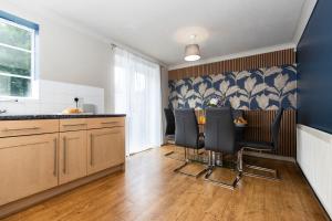 a kitchen with a table and chairs in it at Bridges Retreat, Newcastle in Gateshead