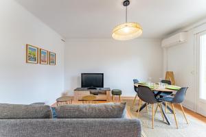 a living room with a couch and a table at Le bel Albi T3 tout équipé & wifi haut débit in La Celle-sous-Gouzon +8 photos