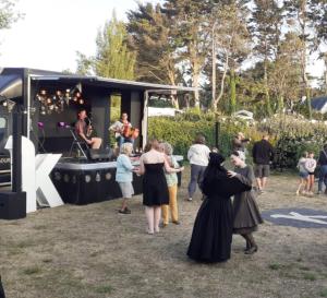 a group of people standing around a food truck at Mobil-home Les volets jaunes in Plouhinec