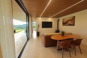 a living room with a table and a couch at Casa de Campo - Valle Paixão in Campo Largo