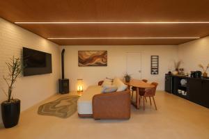 a living room with a couch and a table at Casa de Campo - Valle Paixão in Campo Largo +8 photos