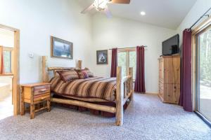 a bedroom with a bed and a television in it at Spacious Pet-Friendly Grand Lake House in Grand Lake