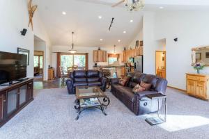 a living room with a couch and a table at Spacious Pet-Friendly Grand Lake House in Grand Lake