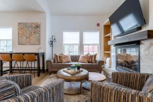 a living room with couches and a fireplace at 3 BR Fraser Apartment in Fraser