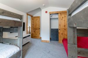 a bedroom with two bunk beds and a tv at 3 BR Fraser Apartment in Fraser