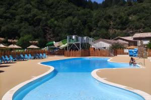 een zwembad in een resort met een waterglijbaan bij Chalet Bungalow 2 Chambres 56 in LʼEstréchure