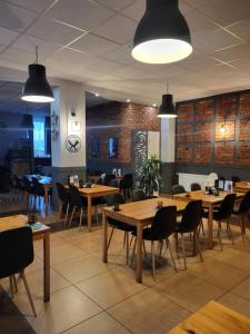 a dining room with wooden tables and chairs at POKOJE APARTAMENTY ANASTAZJA in Grzybowo