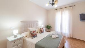 a small bedroom with a bed and a window at Casa Abril by Ruralidays in Setenil