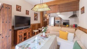 a living room with a couch and a tv at Casa Abril by Ruralidays in Setenil