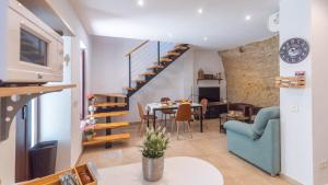 a living room with a table and a dining room at Cueva El Arrabal Setenil by Ruralidays in Setenil