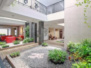 a lobby of a building with plants at Sweet Karina Hotel Pasteur in Bandung