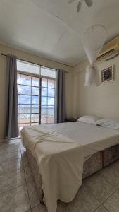 Un dormitorio con una cama grande y una ventana grande. en Ocean Sea view, en Galion