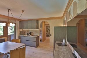 a kitchen with a table and a dining room at Die Seefelderin - Boutiquehotel in Seefeld in Tirol