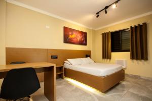 Una cama o camas en una habitación de For Lovers Jabaquara